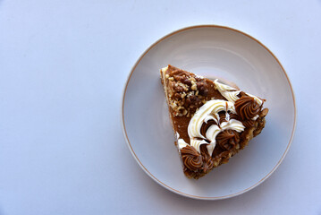 A piece of cake on a plate with nuts