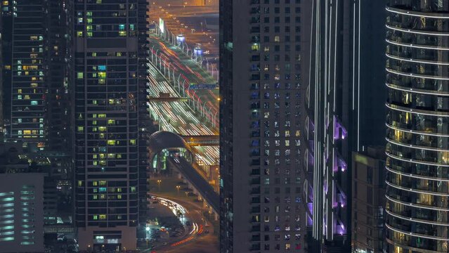 Highway and overpass of Dubai downtown aerial night timelapse.