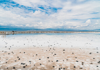 Reflections of the clouds in the clear water of the sea