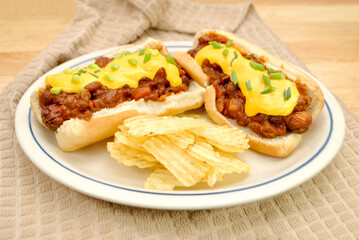 Loaded Chili Dog with Cheddar Cheese and Scallion Served with Wavy Potato Chips	