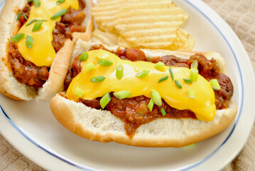 Loaded Chili Dog with Cheddar Cheese and Scallion Served with Wavy Potato Chips	