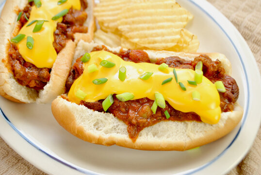 Loaded Chili Dog with Cheddar Cheese and Scallion Served with Wavy Potato Chips	