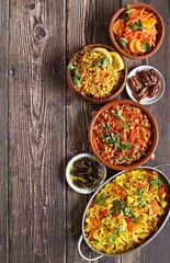 Traditional African dishes assortment. Chakalaka, Ethiopian Cabbage, Couscous salad, Carrot and citrus fruits salad. Selective focus