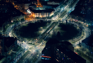 Beautiful aerial view of Skytower Wroclaw city with light buildings and towers at night in Poland