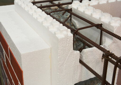 A close-up of an insulated concrete form (ICF) wall with an expanded polystyrene insulation, steel reinforcement filled with concrete as a modern energy efficient building technology.