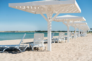white wooden umbrella on the summer sandy beach. idylic coastline resort