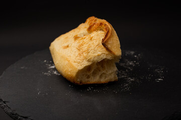 Baked white bread on a black background
