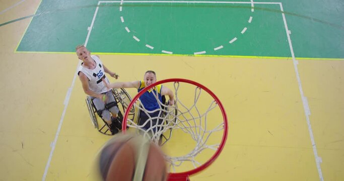 Top view shot of Persons with disabilities playing basketball in the modern hall