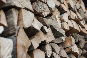 Firewood with logs. Preparing firewood for the winter. Chopped logs are stacked