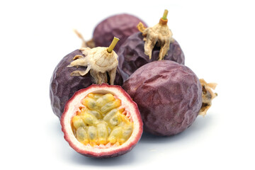 Three slice passion fruit with leaves on white background.