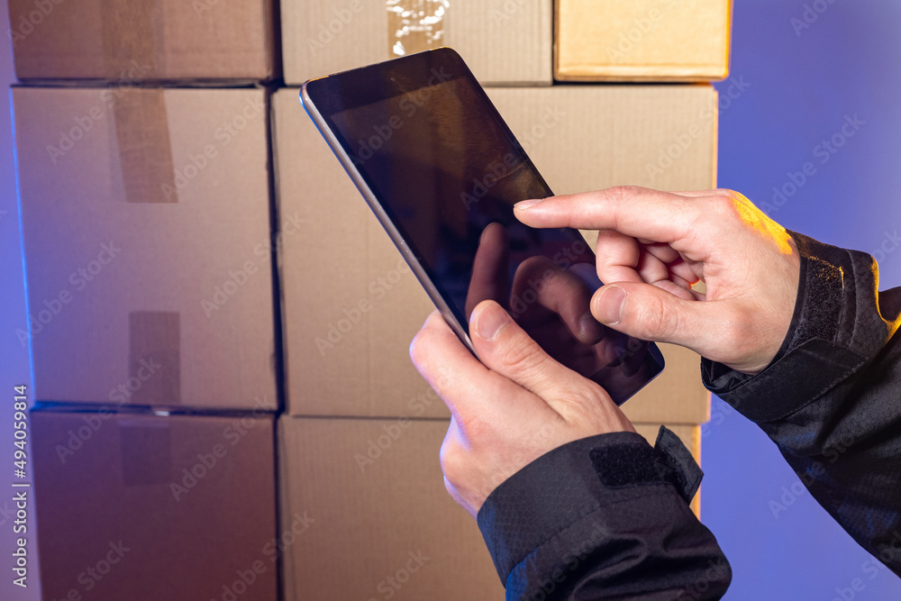Poster warehouse technologies. electronic tablet in hands of man. hands with tablet in front of which are b