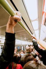 Valencia,Spain-03/05/2022 -hand is clamped on a crowded subway bar.