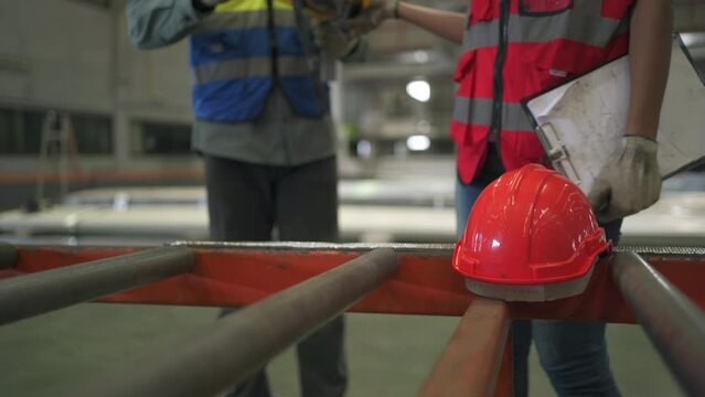 Engineers picking up safety hardhat or helmet before start working.