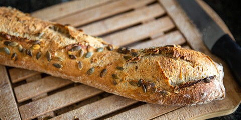 baguette pumpkin seeds french fresh bread fresh portion healthy meal food diet snack on the table...