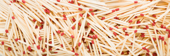 Heap of new match sticks background. Wide banner. Closeup. Top down view.