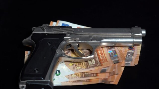 Money cash banknote  50 Euro and revolver gun army - order a murder, criminal underworld and social emergency delinquency  - mafia and criminal life