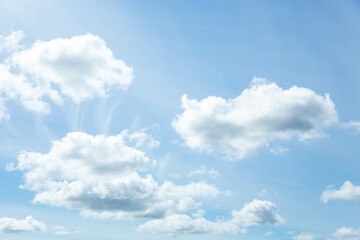 Naklejka na ściany i meble Blue sky with white clouds illuminated by daylight. The background of the blue sky.