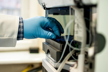 Person working in a laboratory with gloves