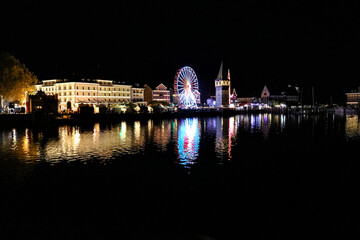 Beautiful view of harbor of Lindau at lake of Constance with a Ferris wheel at night