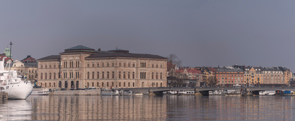 Naklejka premium Panorama view over the bay Strömmen with boats, museums, bridge and piers a sunny spring day in Stockholm