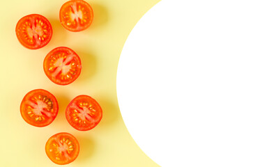 Cut tomatoes on yellow background