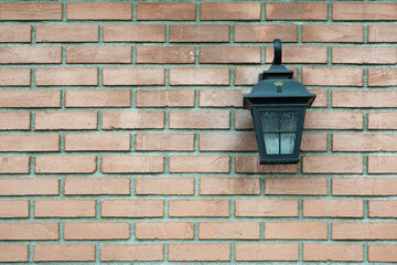 brown brick wall with a lamp.