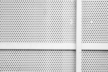 Partial white grated steel door.