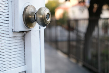 Closeup doorknob on a white steel door.