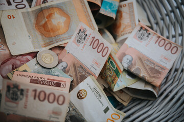 Closeup shot of the 1000 Serbian Dinara banknotes and coins