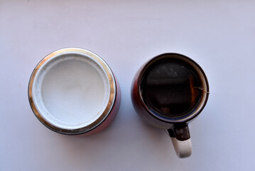 Sugar bowl with a spoon and a mug of tea