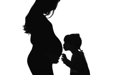 The silhouette of daughter that kiss the pregnant mother