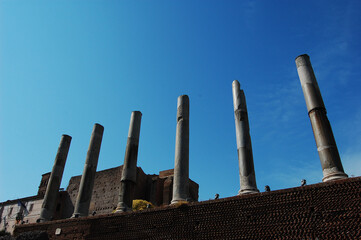 Beautiful view of roman columns of Temple of Venus and Rome against blue sky