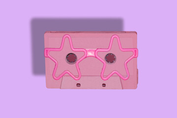 pink cassette with pink star glasses, creative art design music retro cassette on purple backgrounds