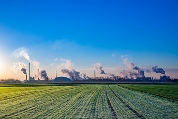 industry landscape in sunrise with smoking chimneys