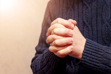 Man during prayer. Prayer for peace in Ukraine. Man's hands during prayer