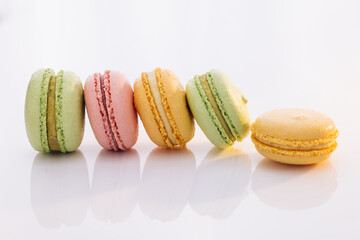 French macarons on white background. Different colorful macaroon. Tasty sweet color macaron. Colorful macarons dessert