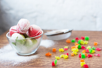Multicolored cookies in the form of Nuts with filled cream, candied fruit and strainer and cup of...