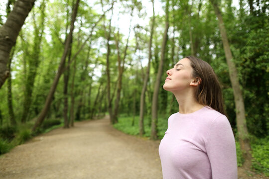 Woman breathing in a forest or park