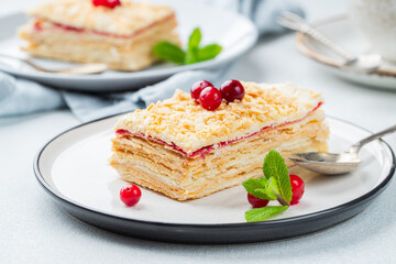 Two pieces of cake Napoleon on white plate. Russian cuisine, multi layered cake with pastry cream, close up view