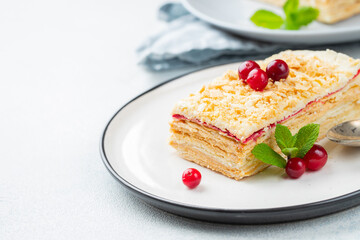 Two pieces of cake Napoleon on white plate. Russian cuisine, multi layered cake with pastry cream, close up view