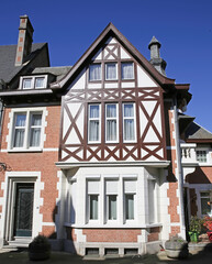 Dinant, Belgium - March 9. 2022: View on half timbered house facade against clear blue sky