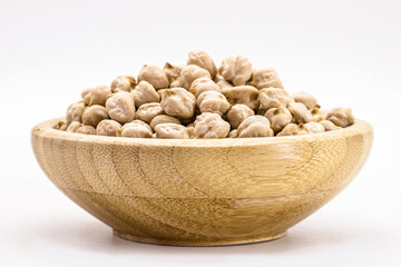 raw chickpeas on white background isolated inside rustic wooden bowl