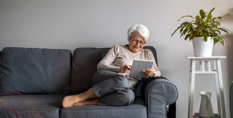 Senior woman using a digital tablet at home
