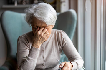 Senior woman suffering from a headache 

