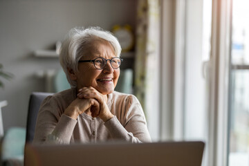 Portrait of smiling senior woman at home
 - Powered by Adobe