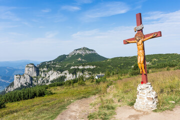 Scenic view of a cross of thetop of  the Ceahlau Massif mountains in Romania