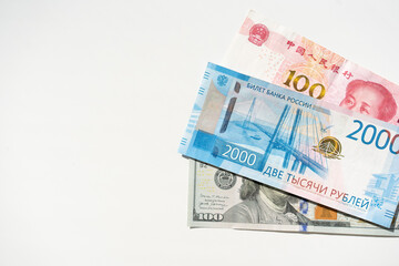 Dollar, ruble and yuan banknotes on the white background. Copy space