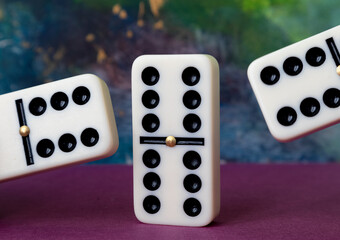 Classic domino chips on a multicolored background. The concept of free time. Game.