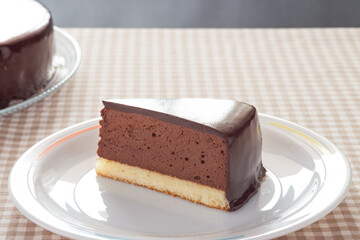 Slice of homemade mousse cake with mirror chocolate coverage