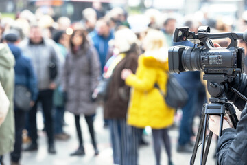 Filming crowd of people with a video camera